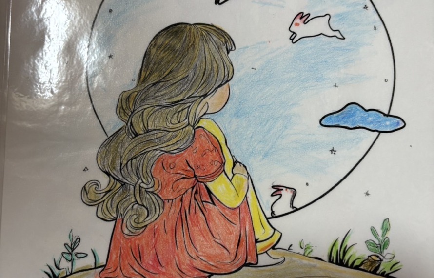 利用者さんが塗られた塗り絵 膝を抱えて座る女性の長い髪が美しく塗られている