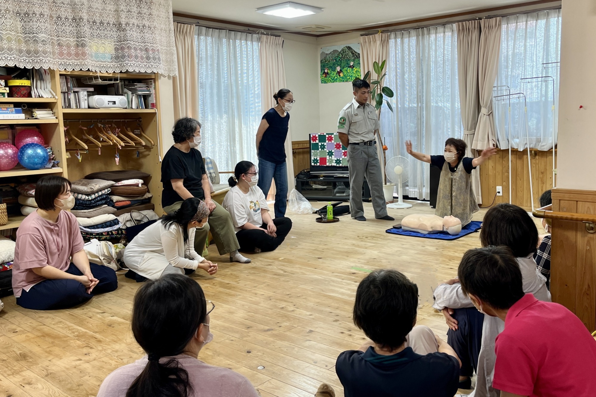 意識不明の人の救助のために周りの人に助けを呼び掛けている様子