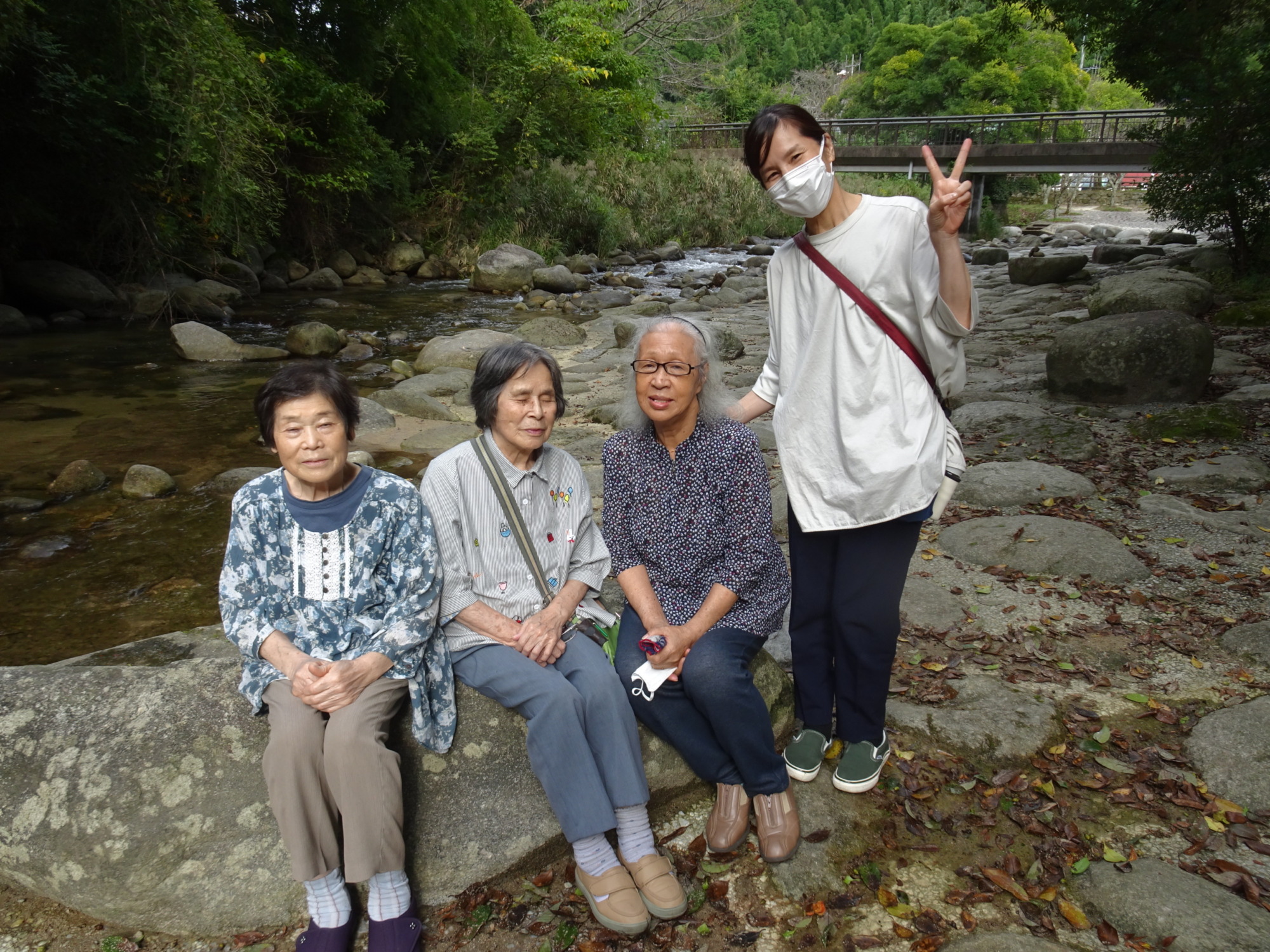 中之島公園の川の前で撮った利用者さんたちとワーカーの写真