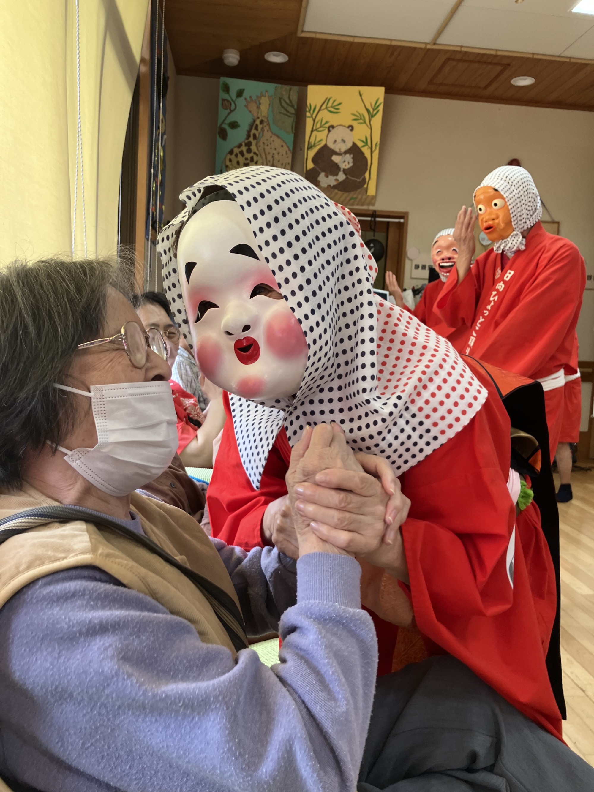 ひょっとこと握手する利用者さん