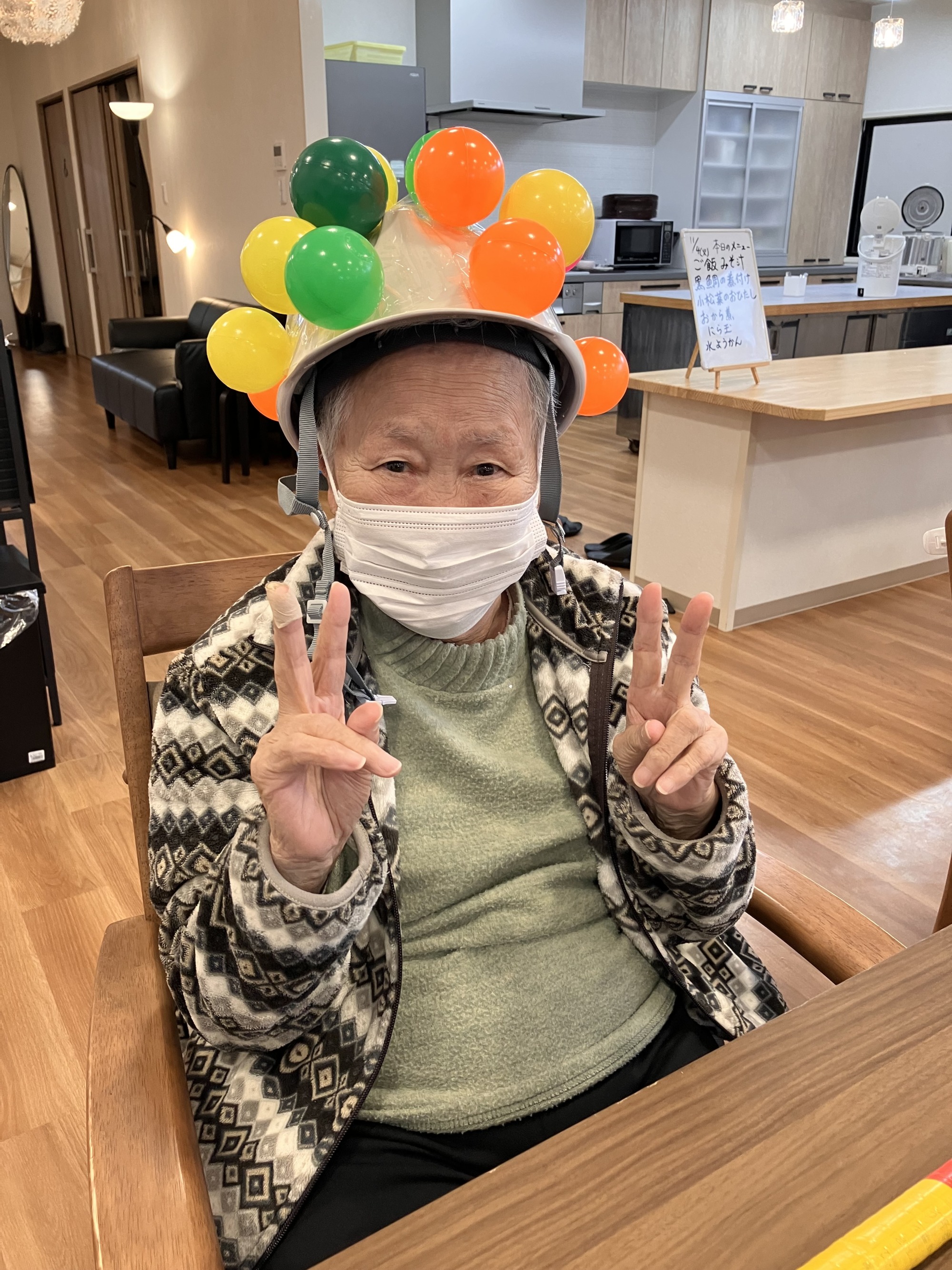 カラーボールのレクレーションを楽しんでにっこり笑う女性高齢者