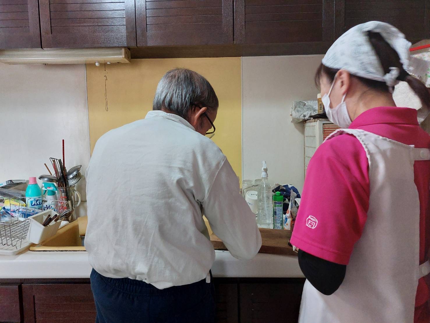 ヘルパーが見守りながら利用者さんが調理をしている