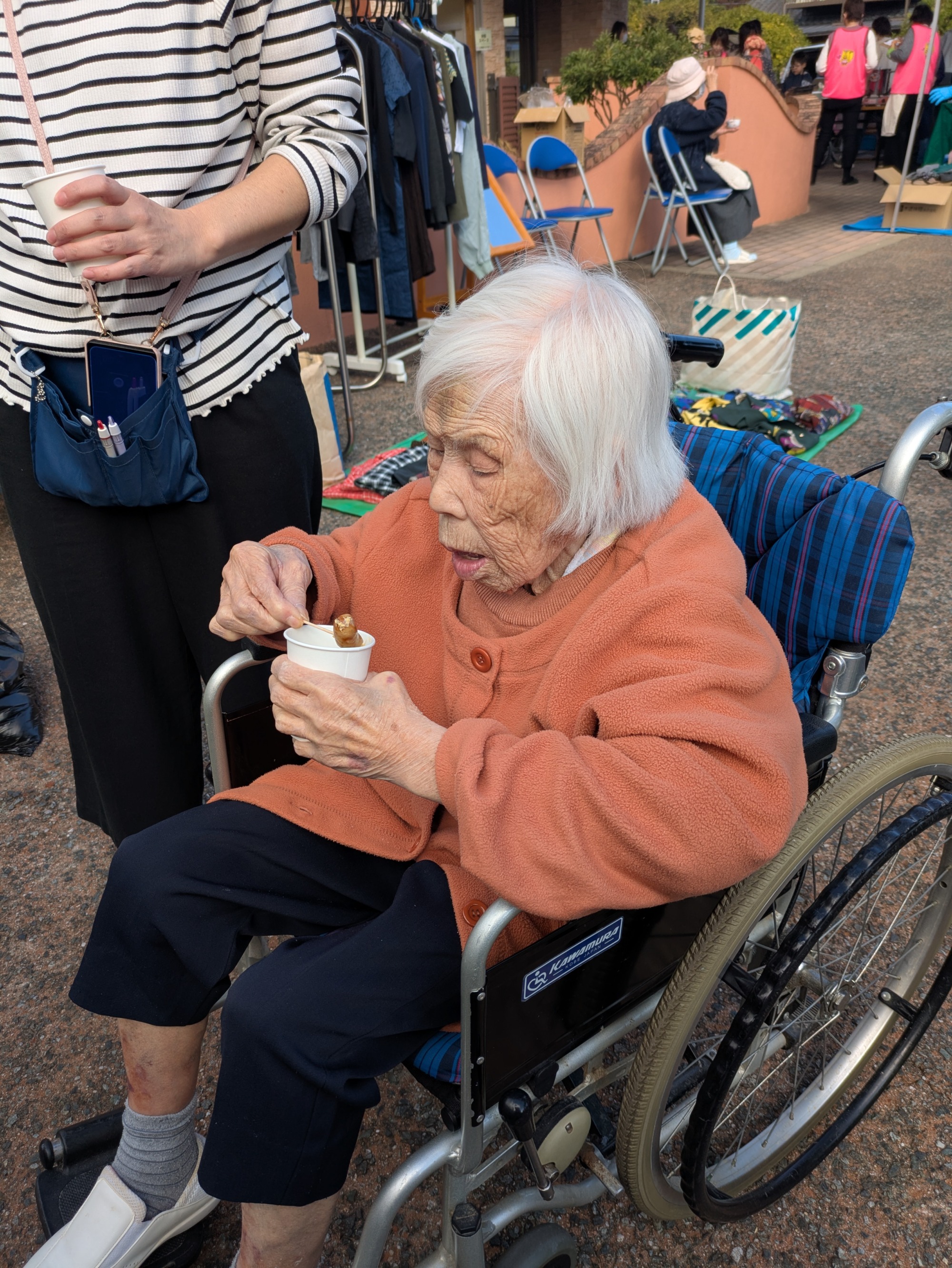 試食のウィンナーを食べる利用者さん