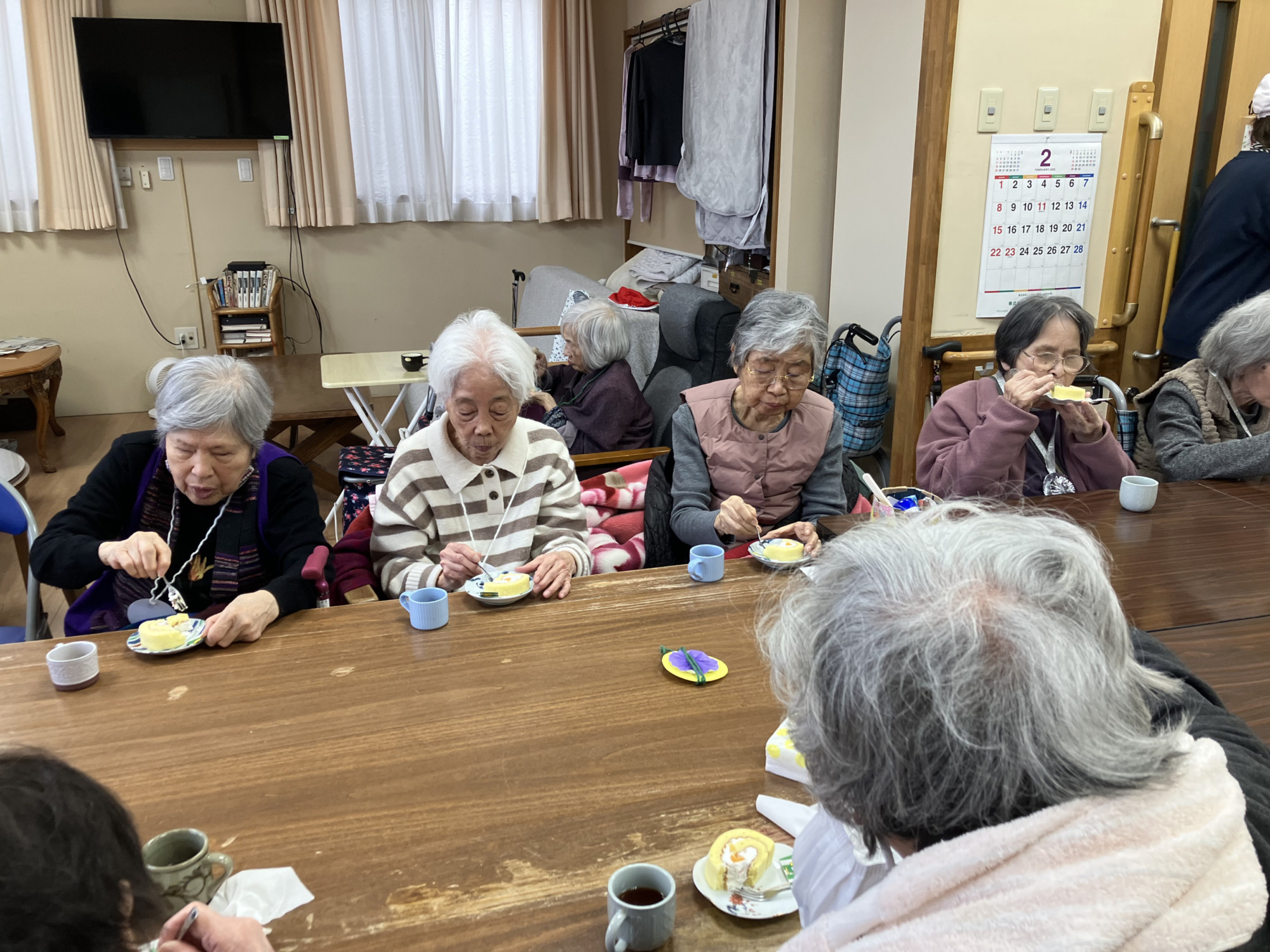 おやつのフルーツロールケーキを食べる利用者さんたち